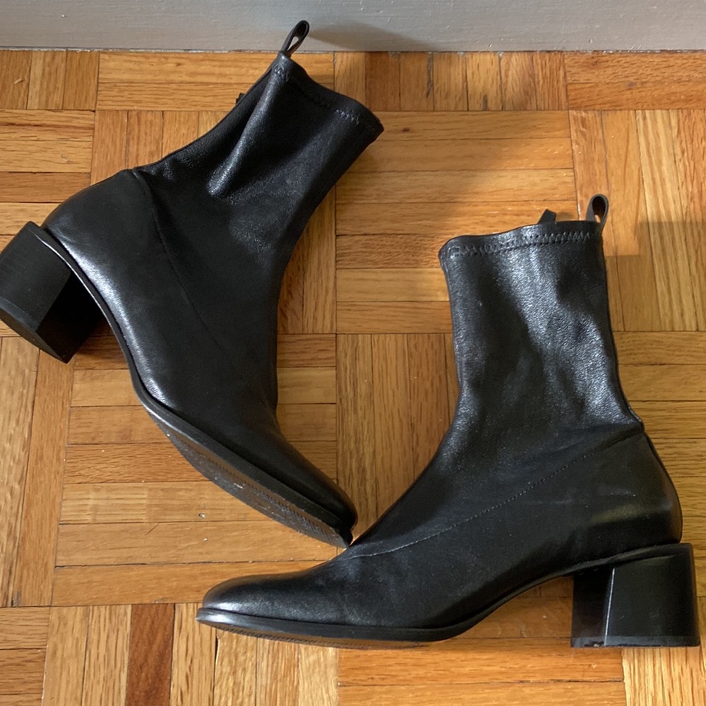 Square toe Black leather stretch bootie with inside zip and block heel.